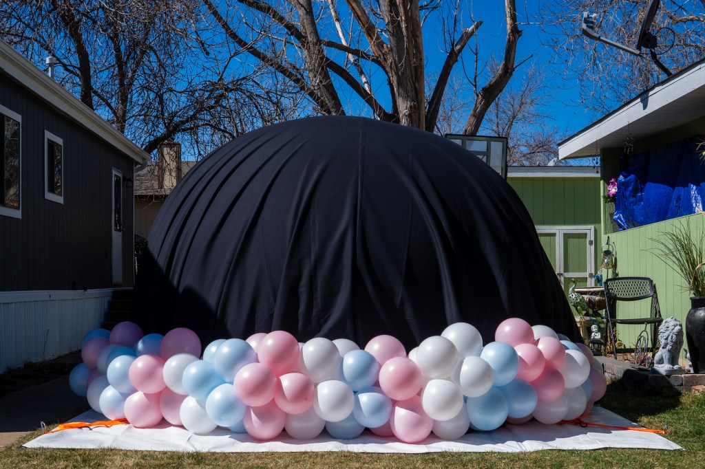 bubble house gender reveal in denver. infltable party rental with balloon decorations