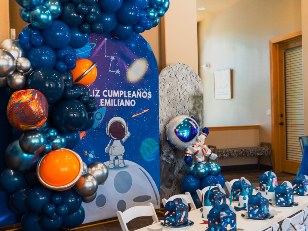 Kids party planner in Denver and surrounding areas. Astronaut balloon garland and installation. Full event styling