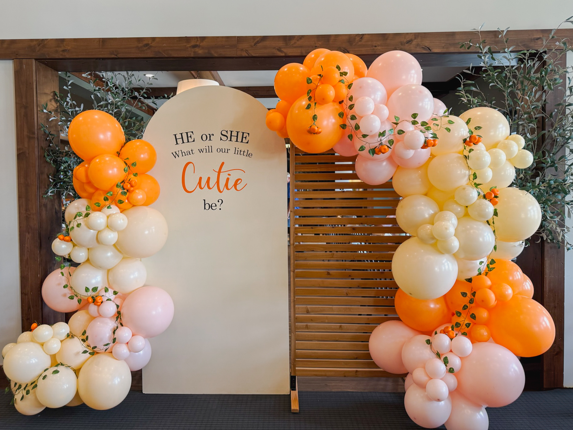 Little Cutie themed gender reveal with orange balloon garland, personalized signage, and premium backdrop rental by Chuchi’s Events in Denver.