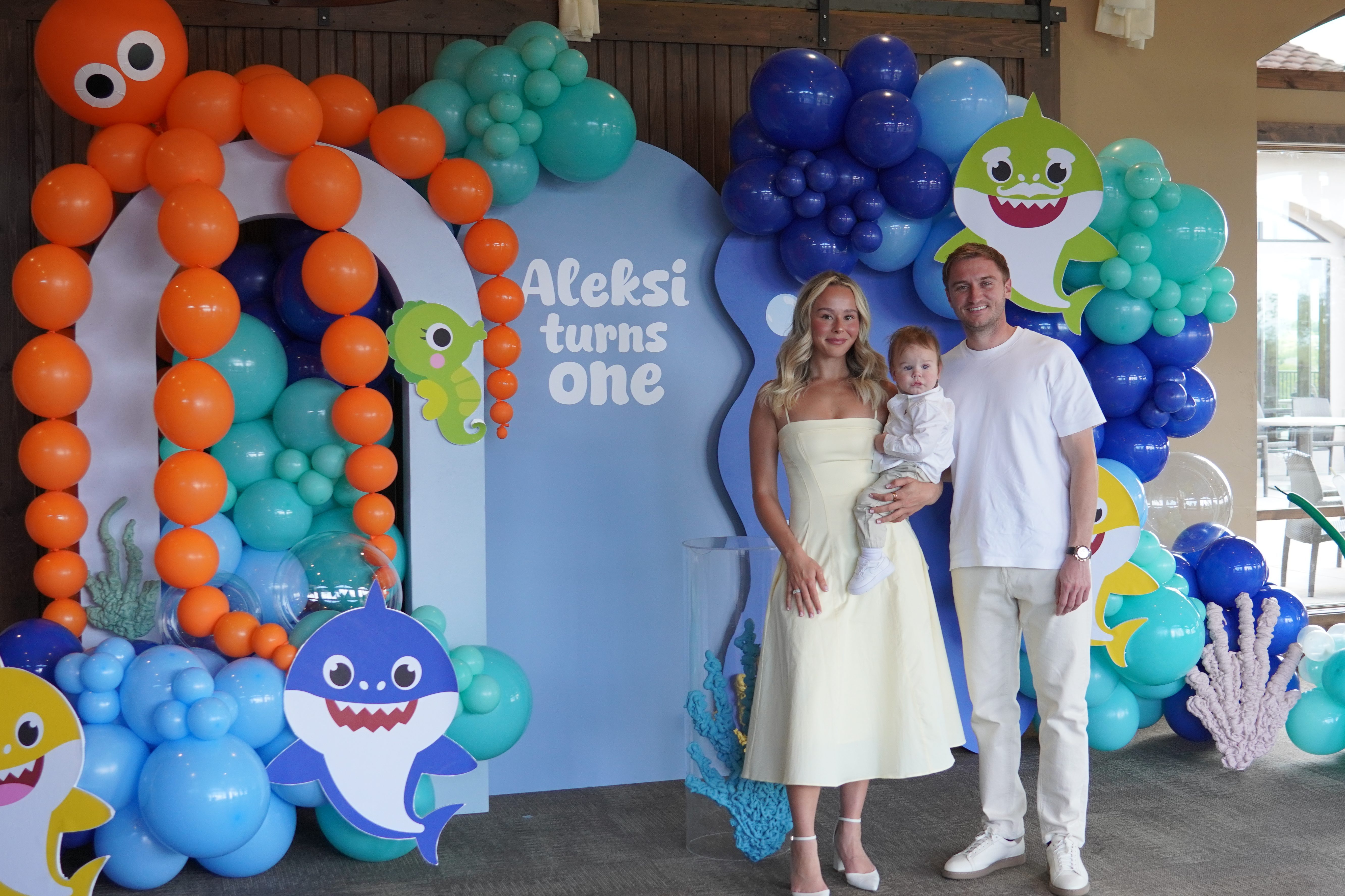Colorful balloon arch and garland setup for a child’s first birthday party in Denver, including Baby Shark themed decorations and festive party balloons.